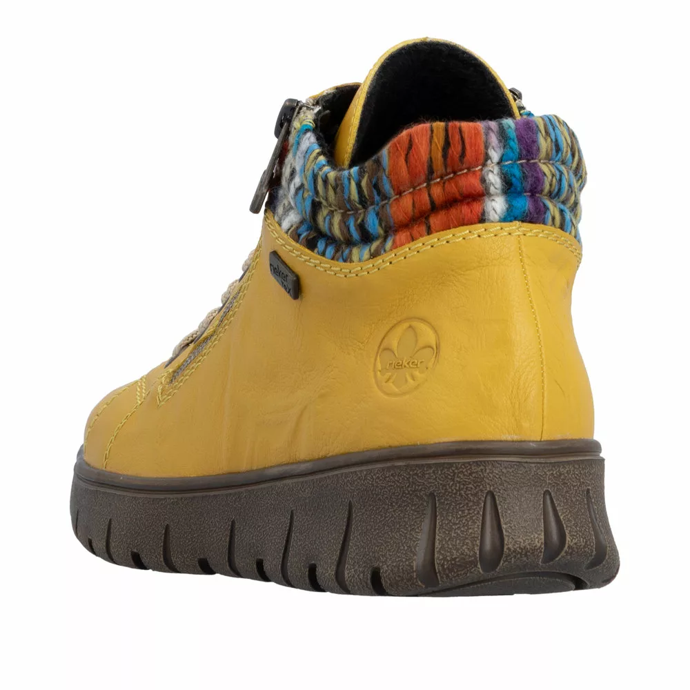 Baskets montantes jaunes de la marque Rieker. Référence : N1305-68 Jaune. Disponible chez Chauss'Family magasin de chaussures à Issoire.